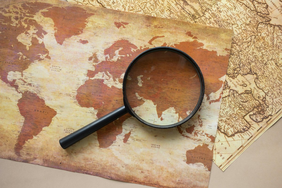 Job Search Strategies A few maps with a black magnifying glass on top of them